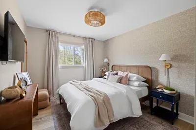 designerbedroomwithcanebedwallpaperandwallsconces