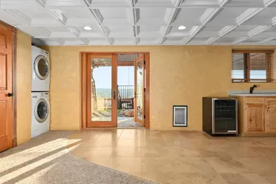 Laundry and half bathroom with access to hot tub & fire pit