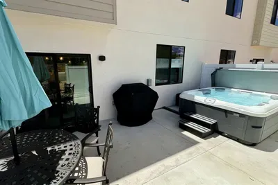 Private patio with hot tub, gas grill and patio furniture