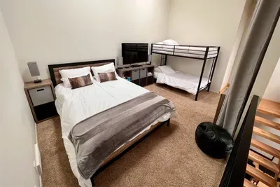 Loft with queen bed and twin bunks