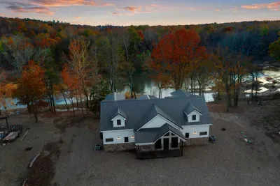 Nestled in beautiful woods with river in back