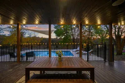 First floor deck with dining area overlooking river and pool