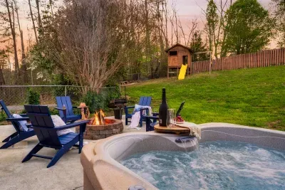 Large fenced backyard with hot tub, fire pit and play set