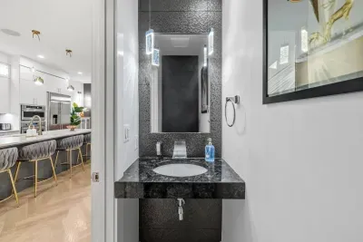 Artful pendant lighting and an accent-tiled feature wall.