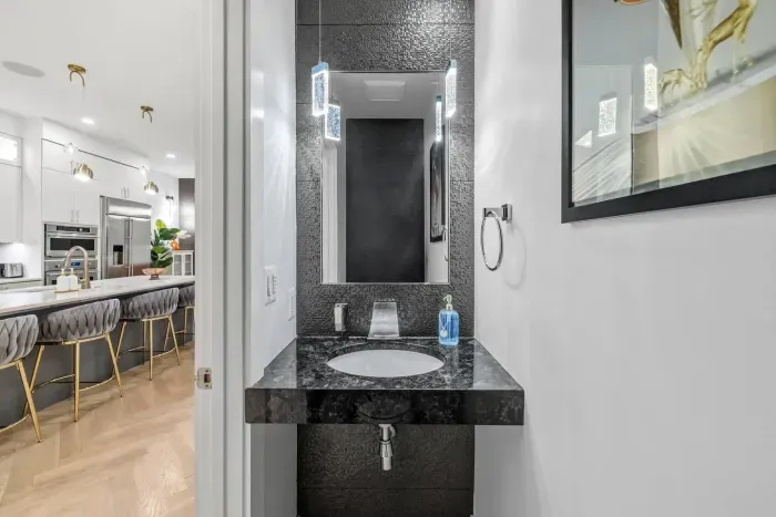 Artful pendant lighting and an accent-tiled feature wall. 
