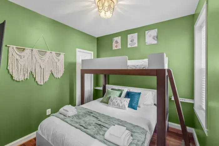 Heavey duty twin over queen bunk bed designed for adults.  Portable charging station on each side of the bed. Smart Roku TV.