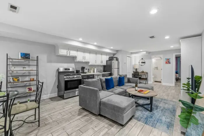 Second living room (Murphy Bed up against the wall). Modular sofa can be rearranged to a queen bed. Fully equipped kitchen.  Dinning table for 4.