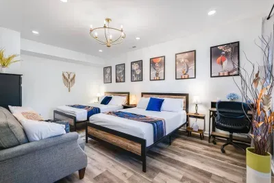 Bedroom #1.  Master bedroom on the first floor with two queen beds, smart TV, 3-seat sofa, work desk, and armoire closet.  Portable heater and additional blankets are provided.
