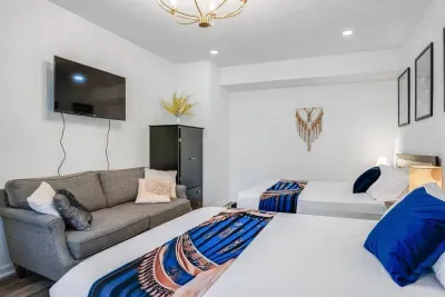 Bedroom #1 (1st Floor). Smart TV, Sofa, Two Queen Beds.