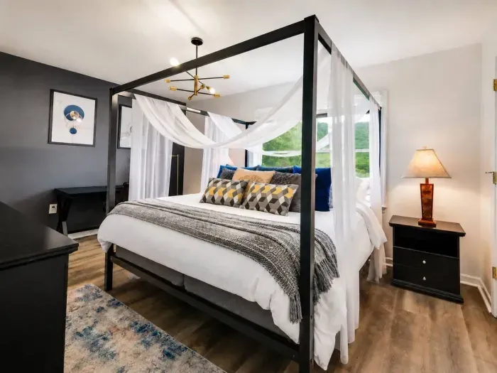 Master bedroom with King Canopy Bed, Mountain View, Work Desk, Smart TV and Ensuite Bathroom.