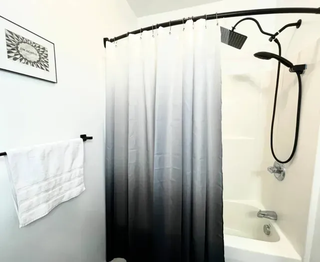 Bathroom #1 (First Floor).  Full Bath.  10'' Showerhead and Handled Showerhead Combo.  Bathtub.  Towels.  Shampoo. Conditioner. Body Soap. Cotton Balls.  Q-Tips.  Hand Soap. Hair Dryer.