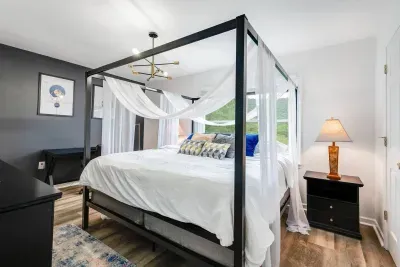 Bedroom #2.  Master Bedroom on 3rd Floor with King size canopy bed, smart TV, dresser, work desk, and ensuite full bathroom.  Great mountain view.