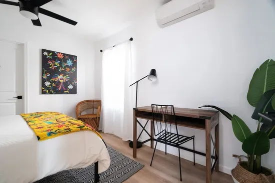 Has a designated work space. Located on the first floor, has a queen bed, and can access the bottom floor bathroom from the room. This is the only bedroom located downstairs.