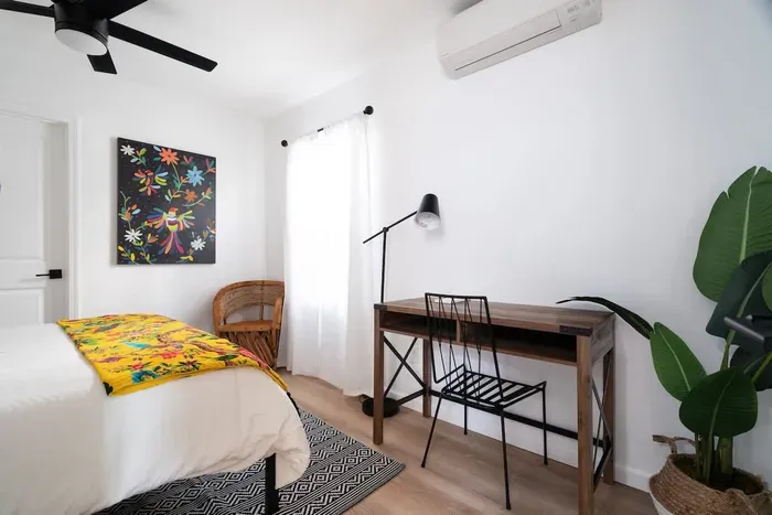 Has a designated work space. Located on the first floor, has a queen bed, and can access the bottom floor bathroom from the room. This is the only bedroom located downstairs.