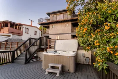 backyard deck with hot tub, fire pit, and seating area to enjoy the city views and sunset!