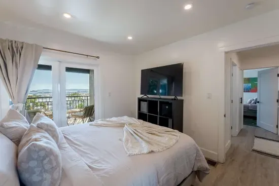 Downstairs bedroom with TV and private balcony with city views!