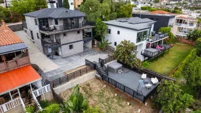 Drone picture of exterior, shows the driveway and where you can park about 2-4 cars. Balconies, hot tub, fire pit for you to enjoy!