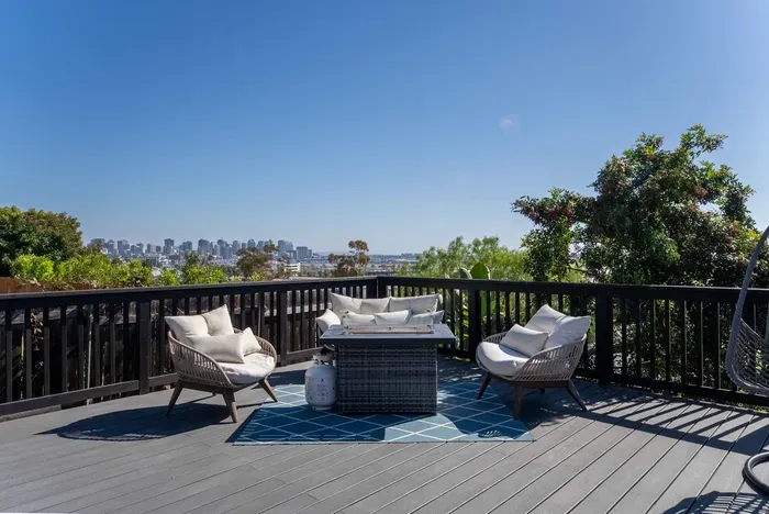 backyard deck with hot tub, fire pit, and seating area to enjoy the city views and sunset!