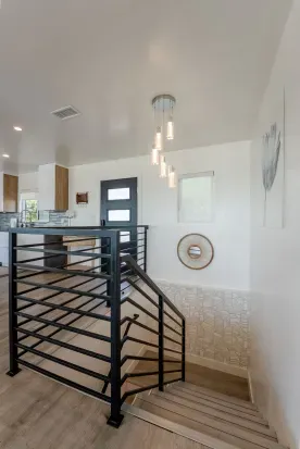 stairwell to get down to the other 4 bedrooms, 1 shared bathroom and a primary bedroom with its own full bathroom.