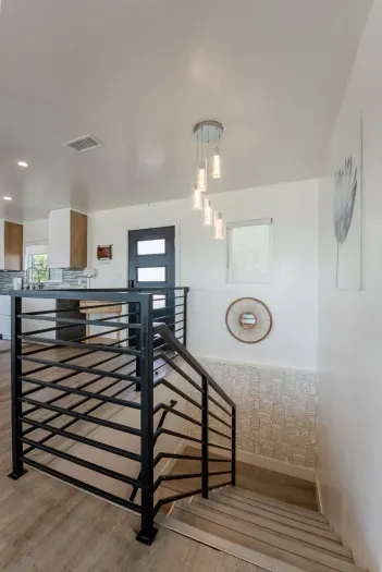 stairwell to get down to the other 4 bedrooms, 1 shared bathroom and a primary bedroom with its own full bathroom.