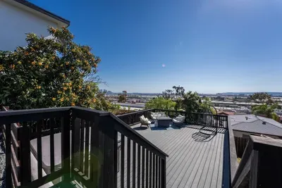 backyard deck with hot tub, fire pit, and seating area to enjoy the city views and sunset!