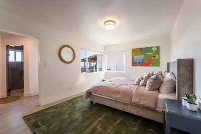 downstairs primary bedroom - King Bed, TV,  Private full Bath and Balcony. Walk In Closet.