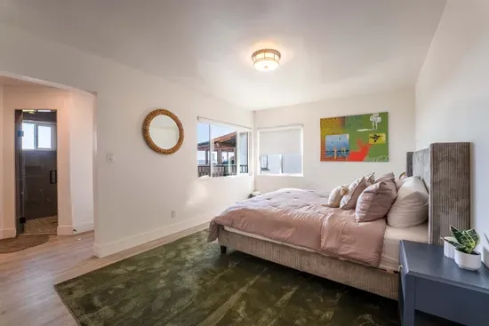 downstairs primary bedroom - King Bed, TV,  Private full Bath and Balcony. Walk In Closet.