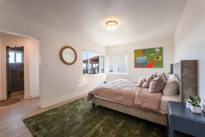 downstairs primary bedroom - King Bed, TV,  Private full Bath and Balcony. Walk In Closet.