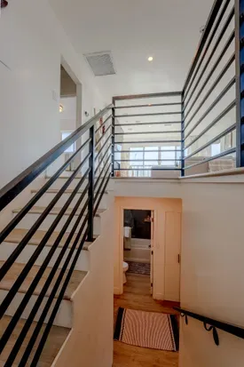 stairwell to get down to the other 4 bedrooms, 1 shared bathroom and a primary bedroom with its own full bathroom.
