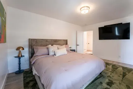 downstairs primary bedroom - King Bed, TV,  Private full Bath and Balcony. Walk In Closet.