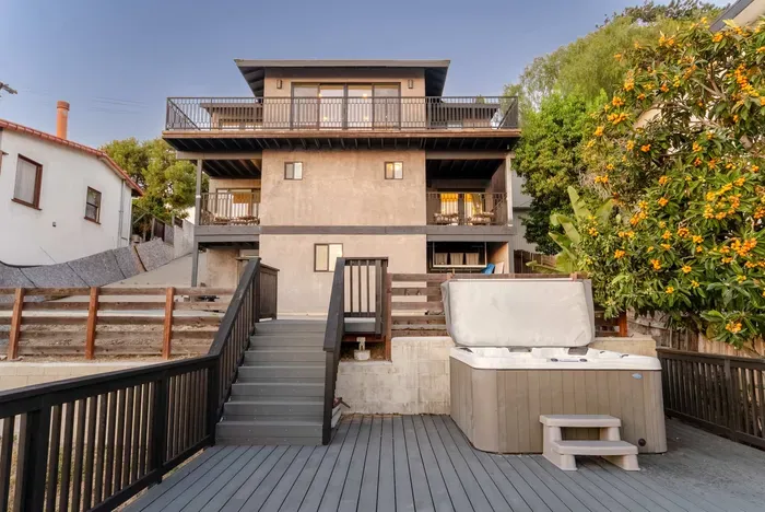 backyard deck with hot tub, fire pit, and seating area to enjoy the city views and sunset!