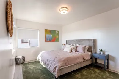 downstairs primary bedroom - King Bed, TV,  Private full Bath and Balcony. Walk In Closet.