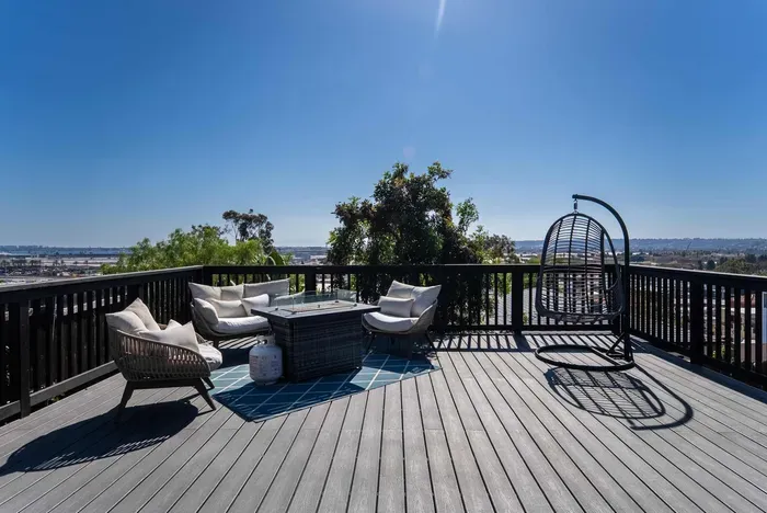 backyard deck with hot tub, fire pit, and seating area to enjoy the city views and sunset!