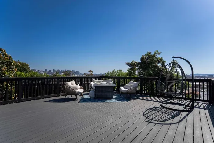 backyard deck with hot tub, fire pit, and seating area to enjoy the city views and sunset!