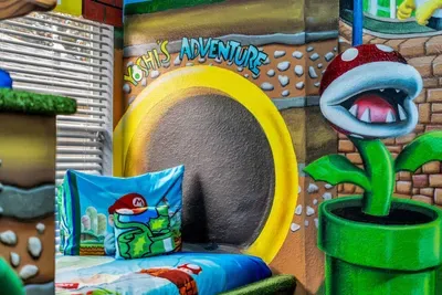 Mario-Themed Room: Snuggle into the 'Yoshi's Adventure' tunnel nook, complete with a Mario throw pillow and Piranha Plant mural!
