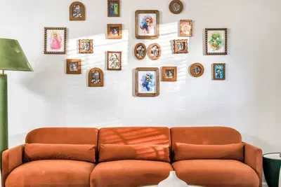 Family Room: Cozy gallery wall of Mario-themed art and a plush burnt-orange sofa set the scene for game nights!