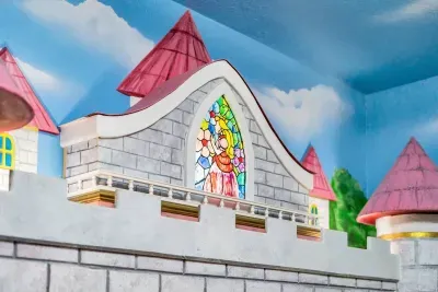 Mario-Themed Room: A stained-glass window featuring Princess Peach crowns the hand-painted castle facade!