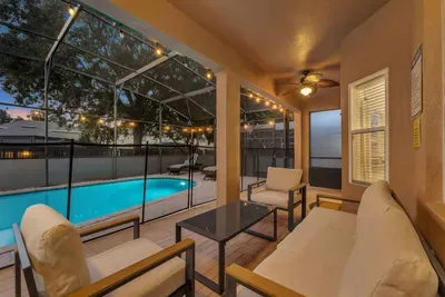 Screened Patio: Twinkling lights and a glowing pool make this covered lounge magical at twilight!