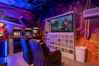 Minecraft-Themed Game Room: Kick back in gaming chairs facing the big screen, with a Nintendo Switch gaming corner and Minecraft inventory-icon wall!