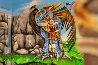 How to Train your Dragon Themed Kids' Room: A hand-painted dragon wraps its wing protectively around its Viking rider!