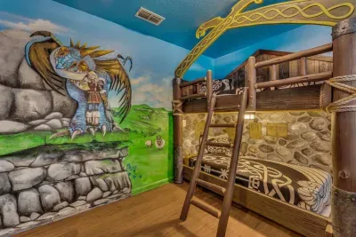 How to Train your Dragon Themed Kids' Room: A soaring dragon-and-rider mural watches over rustic wooden bunk beds with Viking rope trim!