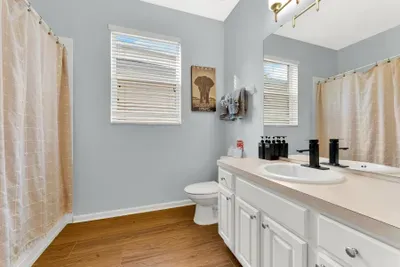 Bright, spacious bathroom with large vanity and natural light