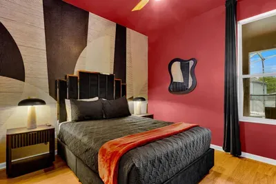 Bedroom 6: Bold red walls and sleek modern furnishings create a sophisticated retreat for the grown-ups!