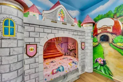Mario-Themed Room: A pink spiral staircase leads into a princess-worthy bunk beneath a colorful stained-glass castle window!