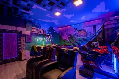 Minecraft-Themed Game Room: Sink into reclining gaming chairs surrounded by a blocky Minecraft landscape mural!