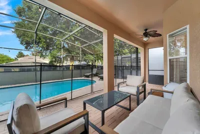 Screened Patio: Sunlit lounge chairs and a shaded sitting area offer the perfect daytime view of the pool!
