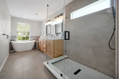 Master bath with a shower room, his and her sink and a tub The master bathroom features a shower room, a separate sink for each occupant, and a bathtub.