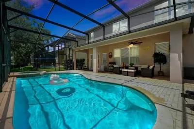 A patio equipped with a swimming pool, spa, and electric grill. 