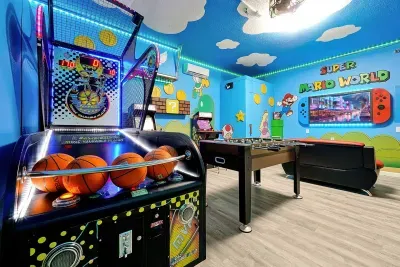Our game room features a basketball arcade, two arcade games, a foosball table, an air hockey table, and a Switch game console. 