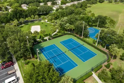 Resort-style tennis courts surrounded by lush green space